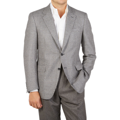 A man is posing for a photo in a Grey Houndstooth Wool Drop 6 Blazer from Canali.