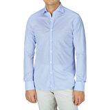 A contemporary man wearing a Canali Light Blue Cotton Jersey Casual Shirt and white pants.