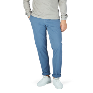 A man wearing Canali Light Blue Cotton Stretch Flat Front Chinos and a grey sweater.