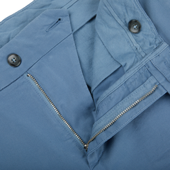 A close up of a distressed Light Blue Cotton Stretch Flat Front Chinos pant with zippers by Canali.