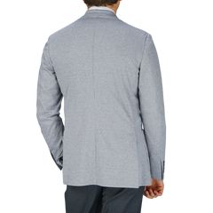 The back view of a man wearing a Canali Light Grey Houndstooth Cotton Jersey Blazer with casual tailoring.