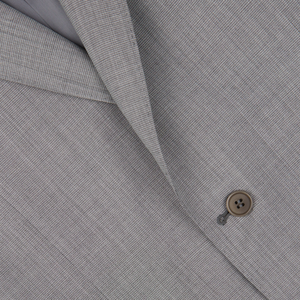 Close-up of a timeless Canali Light Grey Micro Check Wool Suit jacket with a button.