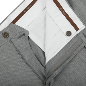 An image of a Canali tailored Light Grey Micro Check Wool Trousers with a brown belt.