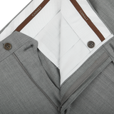An image of a Canali tailored Light Grey Micro Check Wool Trousers with a brown belt.