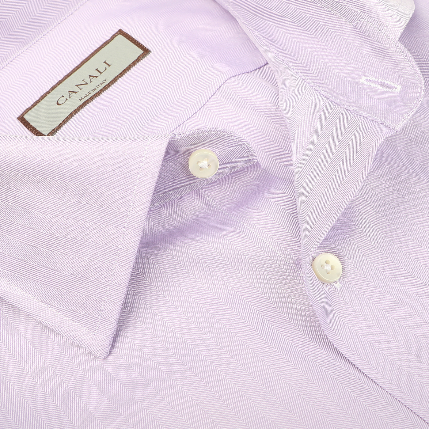 Close-up of the Lilac Cotton Herringbone Single Cuff Shirt by Canali, showcasing its ultra-soft cotton fabric, traditional herringbone pattern, folded collar, and white buttons.