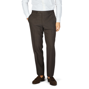 A man wearing Canali Matte Brown Wool Stretch Flat Front Trousers and a white shirt.
