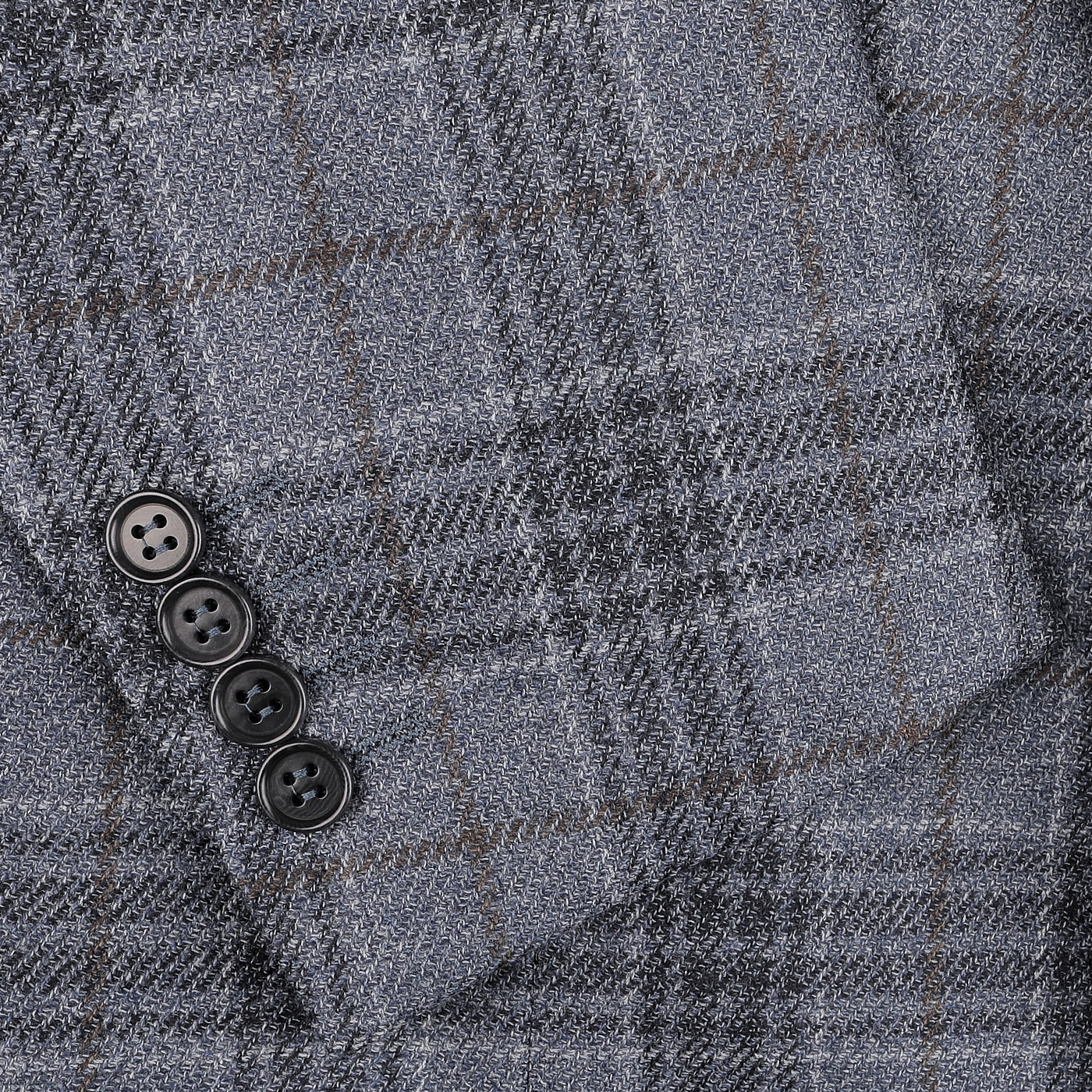 Close-up of a mid blue checked wool-silk blend blazer by Canali, showcasing the sophisticated Milanese house style with distinct black buttons on the cuff.