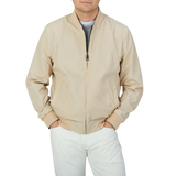 A man wearing a Canali Navy Blue Beige Reversible Technical Blouson with his hands in pockets.