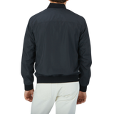 A man in a black Canali Navy Blue Beige Reversible Technical Blouson made of technical nylon.