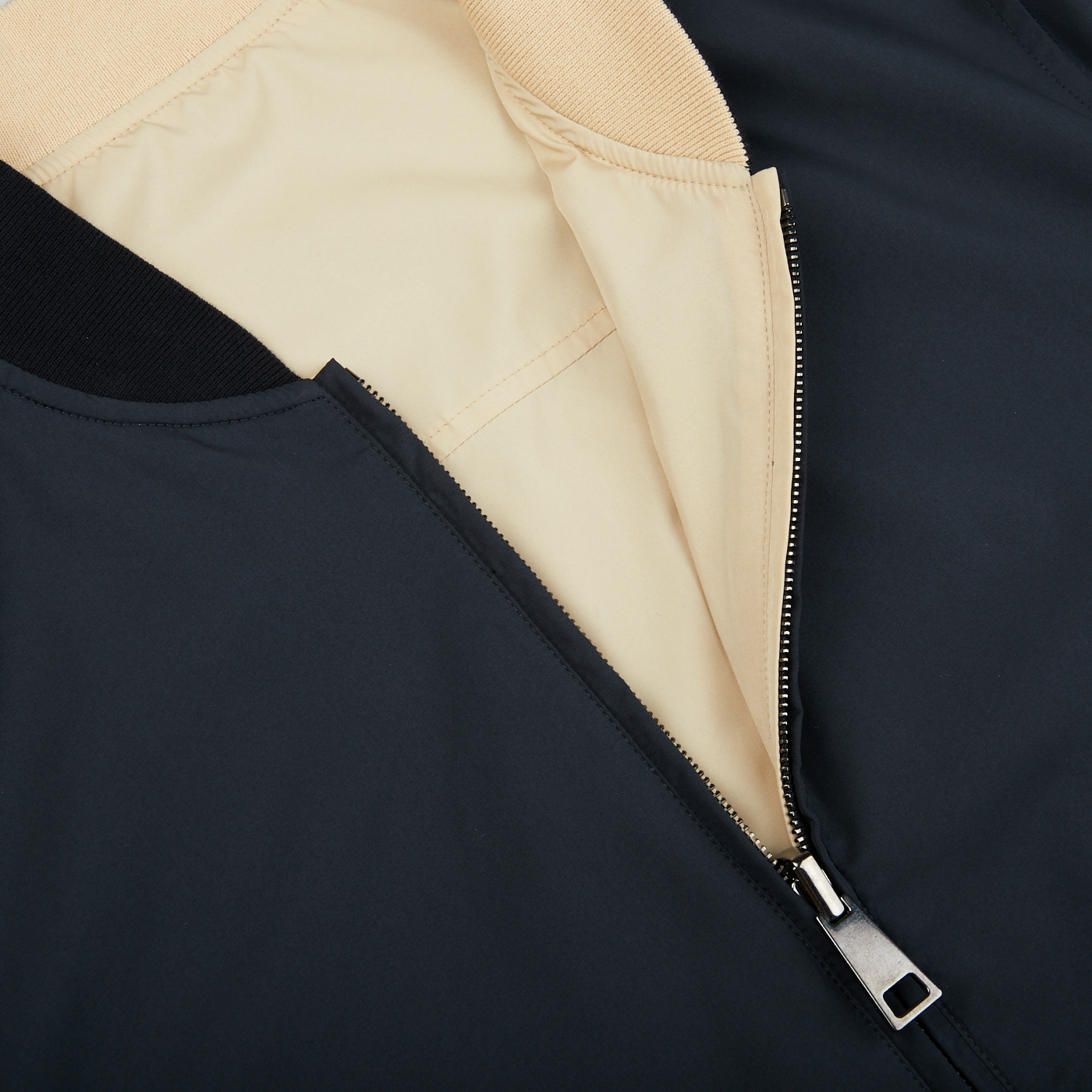 A Canali Navy Blue Beige Reversible Technical Blouson jacket made of technical nylon with a zipper.