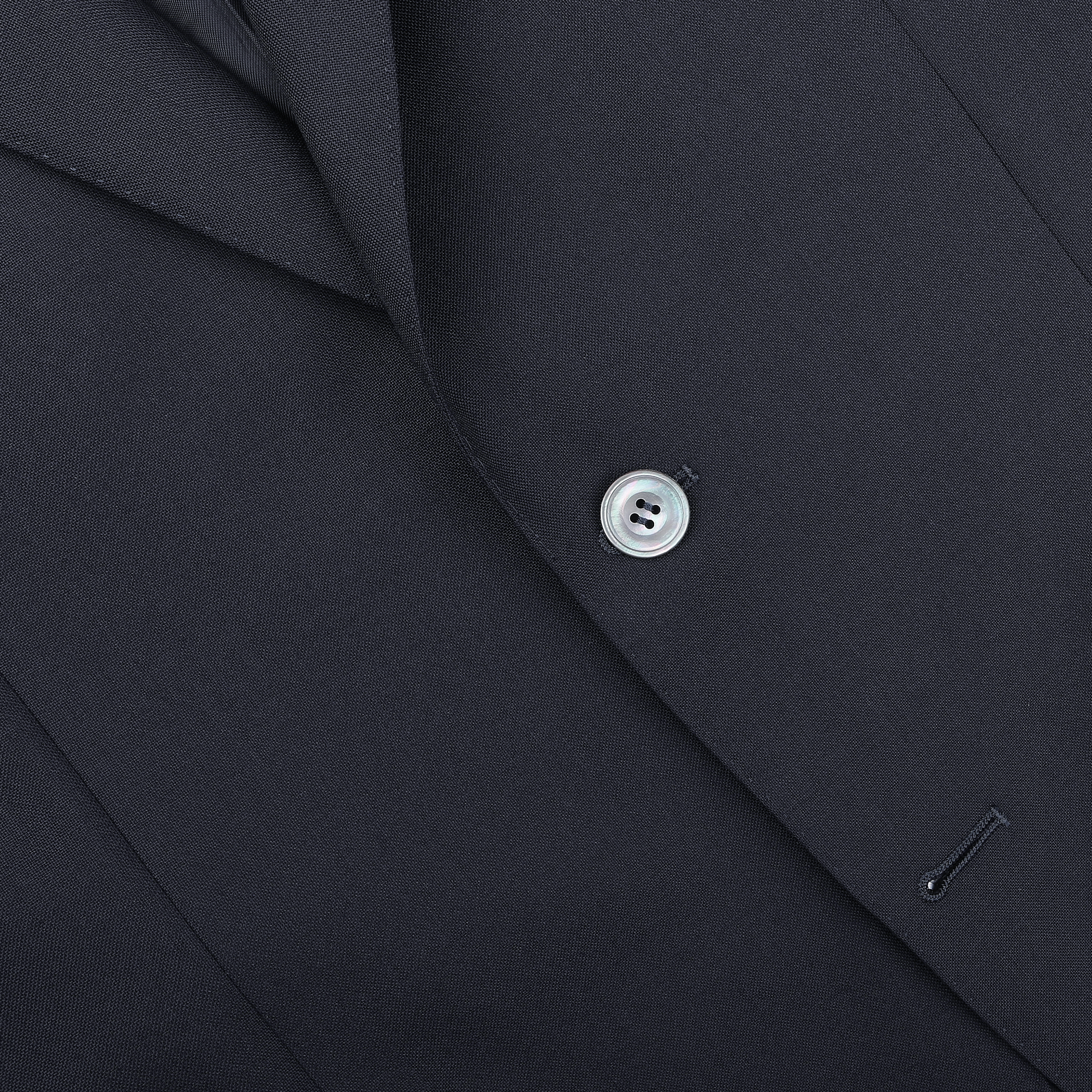 A close-up of the Canali Navy Blue Hopsack Wool Blazer reveals its refined Milanese style, featuring a single visible button and part of the lapel, highlighting elegant craftsmanship.