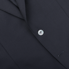 A close-up of the Canali Navy Blue Hopsack Wool Blazer reveals its refined Milanese style, featuring a single visible button and part of the lapel, highlighting elegant craftsmanship.