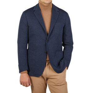 A man dressed in casual tailoring with a Canali Navy Blue Melange Wool Jersey Jacket and tan turtleneck.