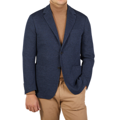 A man dressed in casual tailoring with a Canali Navy Blue Melange Wool Jersey Jacket and tan turtleneck.