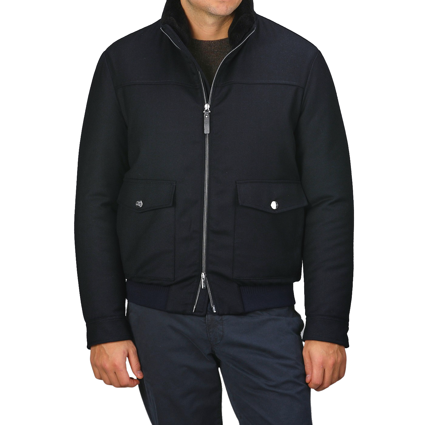 A person wearing the Canali Navy Blue Wool Bomber Jacket, featuring a detachable beaver fur collar, along with dark pants stands against a plain background.