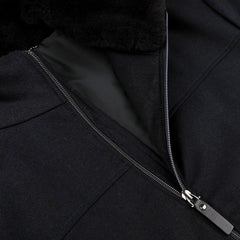 Close-up of a navy blue wool bomber jacket with a partially open zipper, revealing a soft black inner lining and featuring a detachable beaver fur collar by Canali.