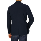 Man from behind wearing a Canali navy cotton jersey unconstructed blazer crafted with casual tailoring and denim jeans.