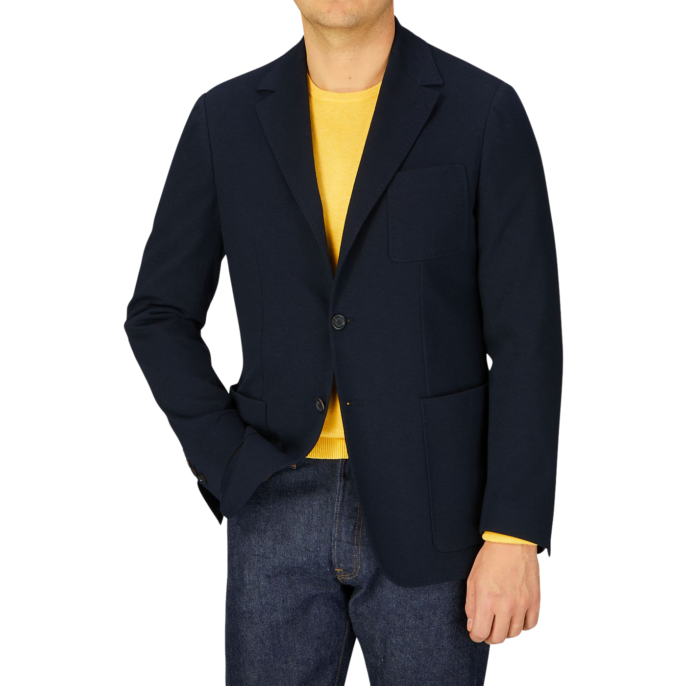 Man wearing a Canali navy cotton jersey unconstructed blazer over a yellow shirt paired with blue jeans.
