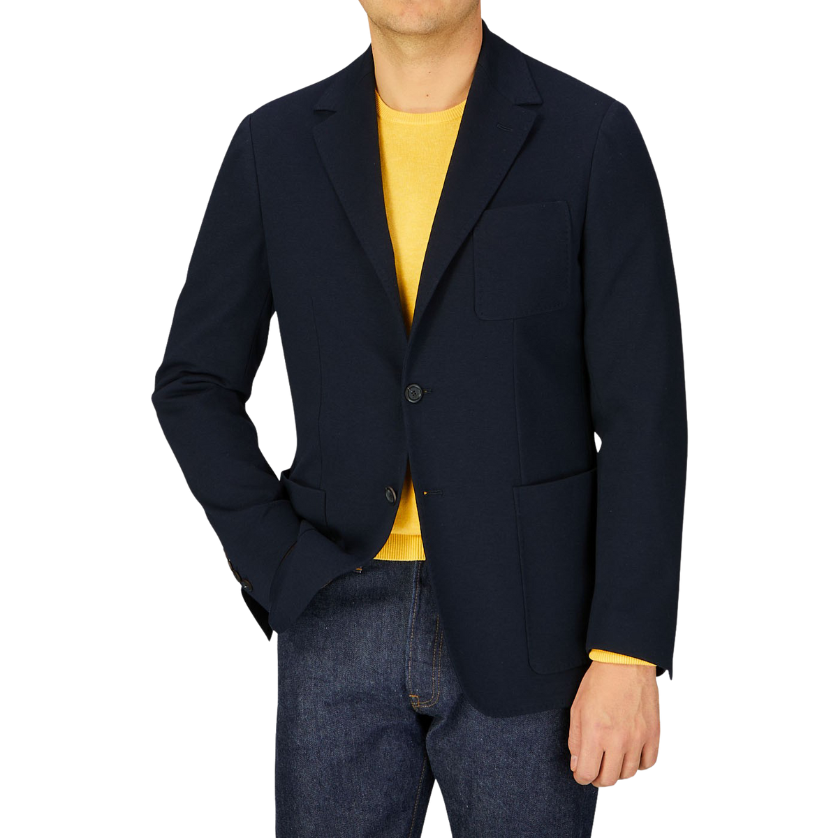 Man wearing a Canali navy cotton jersey unconstructed blazer over a yellow shirt paired with blue jeans.