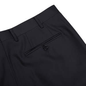 The back pocket of Canali navy blue wool twill formal trousers, made from navy blue wool twill fabric.