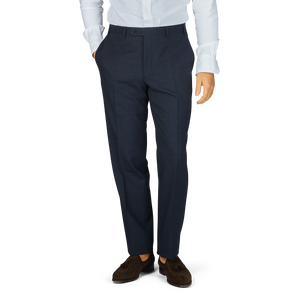 A man wearing Canali Navy Puppytooth Wool Stretch Flat Front Trousers and a white shirt.