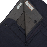 A pair of Canali Navy Puppytooth Wool Stretch Flat Front Trousers with a pocket on the side crafted from wool fabric.