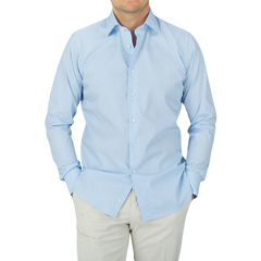 A man wearing a Canali Plain Blue Cotton Poplin Single Cuff Shirt.