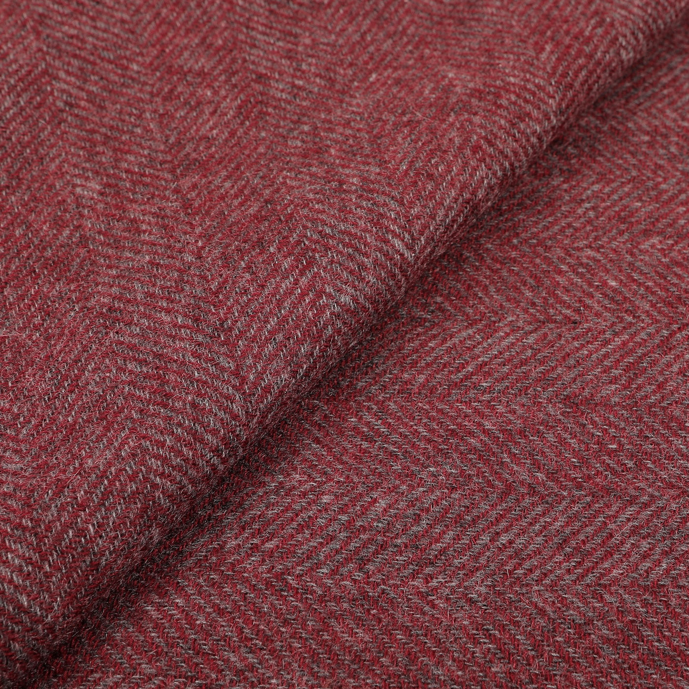 Close-up of the Red Grey Herringbone Cashmere Scarf by Canali, featuring a diagonal weave pattern that evokes the luxurious touch characteristic of the brand.