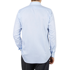 The back view of a man wearing a Canali Sky Blue Cotton Single Cuff Shirt.