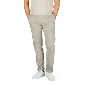 A man in a beige cotton sweater and Canali Stone Beige Cotton Stretch Flat Front Chinos.