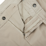 A close up of a pair of distressed Stone Beige Cotton Stretch Flat Front Chinos with zippers by Canali.