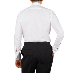 The back view of a man wearing the Canali White Cotton Double Cuff Pleated Dress Shirt.