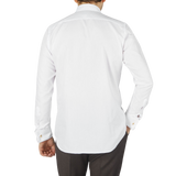 The back view of a man wearing a Canali White Cotton Double Cuff Plain Dress Shirt.