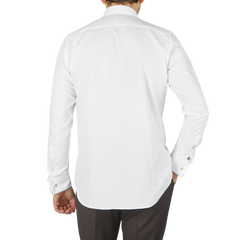 The back view of a man wearing a Canali White Cotton Double Cuff Plain Dress Shirt.