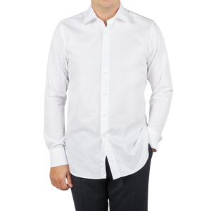 A man wearing a Canali white cotton single cuff shirt made from ultra-soft cotton.