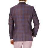 Rear view of a person wearing a Canali wine red checked wool silk linen blazer and light pink trousers, standing against a plain background.
