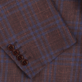 Close-up of a wine red checked Canali wool silk linen blazer with buttons, showcasing the texture and pattern of the material.