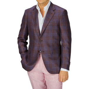 A man wearing a Canali wine-red checked wool silk linen blazer over a white shirt, paired with pink trousers, focusing on the upper half of his body.