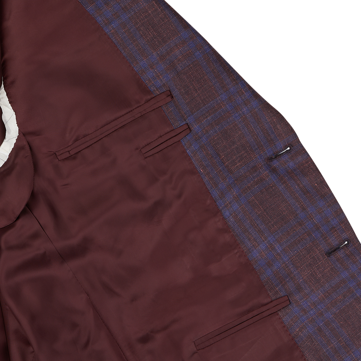 Detail of a Canali wine red checked wool silk linen blazer showing the texture of the fabric and pockets on a white background.