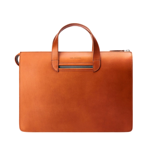 The Carl Friedrik Cognac Vachetta Leather Vallance Slim Briefcase is a streamlined accessory featuring a handle and zippered top closure, crafted from premium Italian vachetta leather against a plain background.