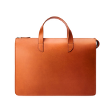 The Cognac Vachetta Leather Vallance Slim Briefcase by Carl Friedrik is a streamlined brown leather briefcase crafted from Italian vachetta leather. It features two handles and a zipper closure, showcasing a minimalist design that speaks to sophistication and functionality against a white background.