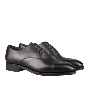 A pair of Carmina black calf leather captoe Rain Oxford shoes, crafted by Carmina craftsmen, with laces.