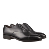 A pair of Carmina black calf leather captoe Rain Oxford shoes, crafted by Carmina craftsmen, with laces.
