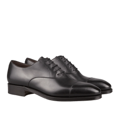 A pair of Carmina black calf leather captoe Rain Oxford shoes, crafted by Carmina craftsmen, with laces.