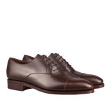 A pair of Carmina's Brown Calf Rain Captoe Rain Oxford Shoes with laces, crafted by expert craftsmen.