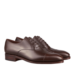 A pair of Carmina's Brown Calf Rain Captoe Rain Oxford Shoes with laces, crafted by expert craftsmen.