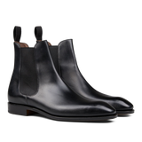 A pair of Carmina Black Calf Leather Simpson Chelsea Boots with elastic side panels, crafted by skilled craftsmen.