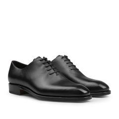 The Carmina Black Calf Leather Wholecut Rain Oxford Shoes are expertly crafted with premium calf leather, featuring round toes and closed lacing, along with a Goodyear welted construction that is visible from the side.