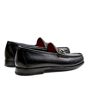 A pair of Black Funchal Leather Xim horsebit loafers by Carmina on a white background.