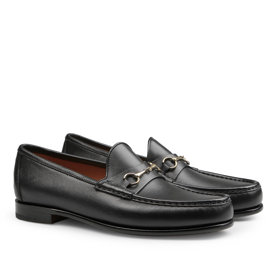 Black Funchal Leather Xim Horsebit Loafers by Carmina, crafted from black calf leather, feature a silver metal buckle detail, a low heel, and elegant stitching along the top edge.